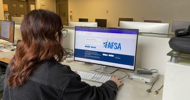 A student sitting down getting ready to fill out the FAFSA application.