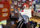 An altar is shown at a Dia de muertos festival. There is a skeleton in front of the altar holding a sign that says, "8 lives can be saved by just every 1 person through organ donation."